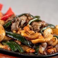 Parrilla Poblana · A traditional mix of beef and chicken fajitas, poblano peppers, onions and bacon grilled to ...