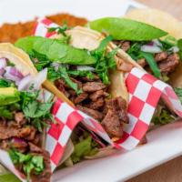 Jumbo Street Tacos · Three corn tortilla tacos filled with beef fajita, onions, cilantro, and a slice of avocado....