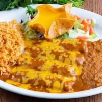 Tamales · Four pork tamales topped with gravy and cheese. Served with rice, beans, and a cheese puff.