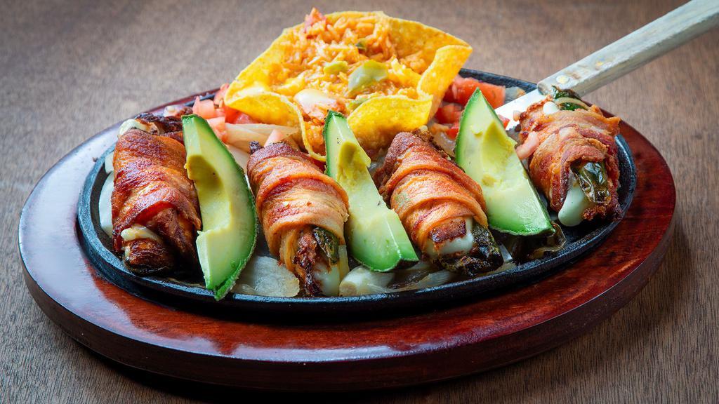 Chicken Diablos · Four strips of chicken stuffed with a mild slice of jalapeño and a slice of queso fresco, wrapped in bacon. Served with charro beans and rice with cheese on top.