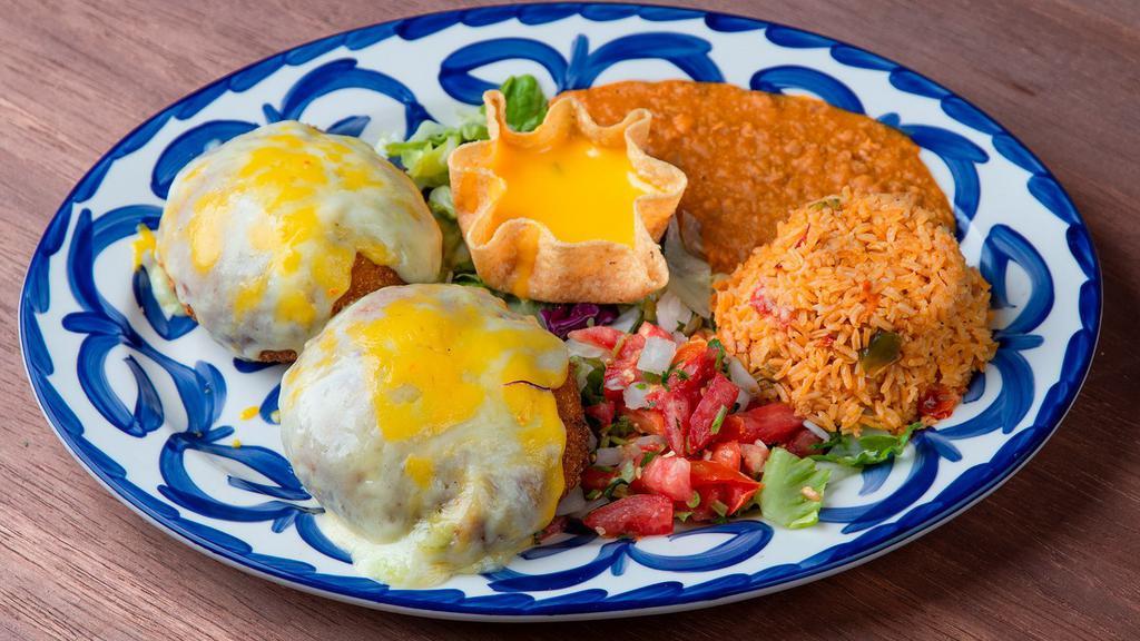 Stuffed Avocado · Two fried avocado halves stuffed with chicken fajita, and Monterey jack cheese. Served with rice, beans, cheese puff, and pico de gallo. Substitute shrimp for an additional charge.