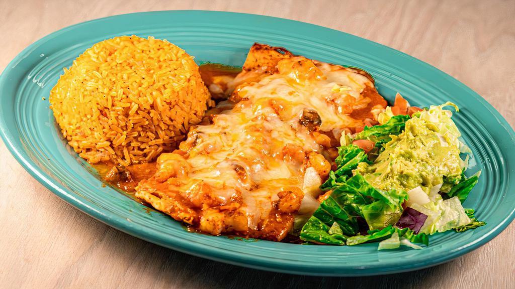 Pechuga Jalisco · Grilled chicken breast topped with red sauce and melted Monterey Jack cheese. Served with rice, beans, a cheese puff and tortillas.