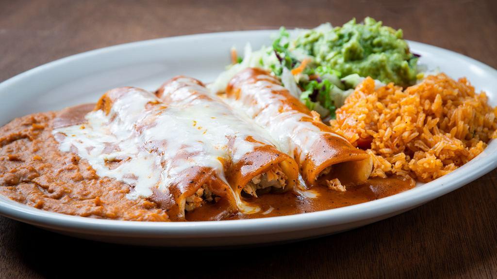 Enchiladas Al Carbon · Three fajita enchiladas covered in gravy and Monterey Jack cheese. Served with rice, beans and guacamole.
