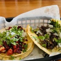 Barbacoa Taco · authentic homemade barbacoa in a flour or corn tortilla, topped with onions and cilantro.