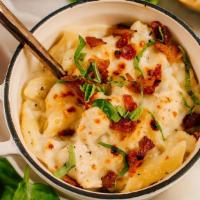 Baked Penne Chicken Alfredo · Diced chicken and penne pasta tossed in a creamy alfredo sauce and baked to perfection in ab...