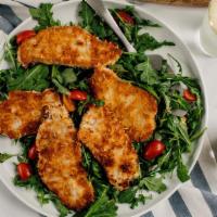 Pork Chop Milanese · Lightly breaded pork chops are cooked to golden brown and finished with a lemon caper sauce....