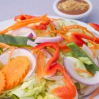 Garden Salad · Mixed green lettuce, onions, cucumber, carrots, bell peppers and tomatoes with peanut dressi...