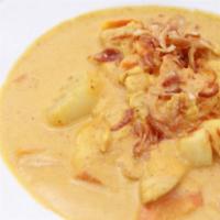 Yellow Curry · Yellow chili paste, potatoes, onions, carrots, and coconut milk.
