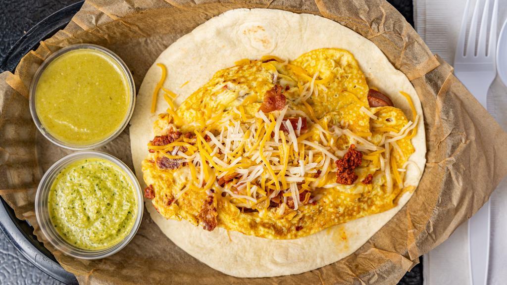 3 Puerquitos Taco! · A 6 inch flour tortilla with scrambled eggs, chorizo, bacon, and sausage topped with our mixed cheese.