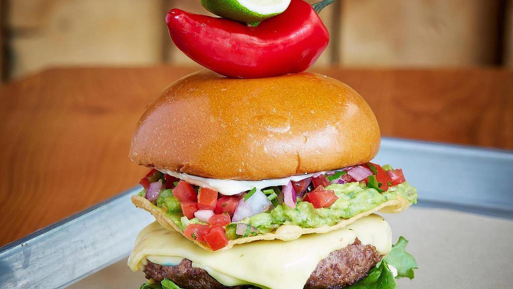 El Luchador Burger · Grilled jalapeno, pepper jack, guacamole, chipotle mayo, tostada, pickled red onion.