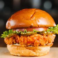 Hot Chick Burger · Buttermilk fried chicken, Buffalo sauce, blue cheese sauce, lettuce, onion, tomato.