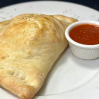 Sausage Calzone · Our home made dough baked & stuffed with sausage, ricotta, & mozzarella cheese. Served with ...