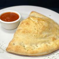 Spinach Calzone · Our home made dough baked & stuffed with spinach, ricotta, & mozzarella cheese. Served with ...