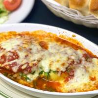 Spinach Ravioli · Stuffed spinach raviolis sautéed in our fresh marinara sauce. Topped with melted mozzarella ...