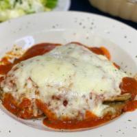 Eggplant Parmesan · Lightly breaded fried eggplant, topped with marinara sauce & mozzarella cheese. Served with ...