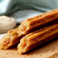 Churro Stick · Our spin on the classic beloved snack, baked to perfection and topped with our world-famous ...