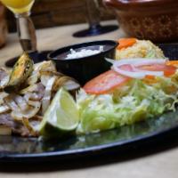 Encebollado · Grilled beef steak topped with grilled onions. Served with rice and beans.