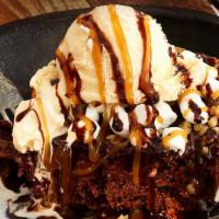 Insanity Brownie · Chocolate brownie topped with marshmallows, walnuts, chocolate and caramel sauce with a doll...