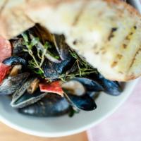 Black Mediterranean Mussels · Spicy salumi, garlic butter, fresh herbs, grilled bread.
