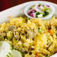 Yellow Curry Fried Rice · Spicy. Jasmine rice fried with pineapples, diced carrots, diced onions, diced scallions, pea...