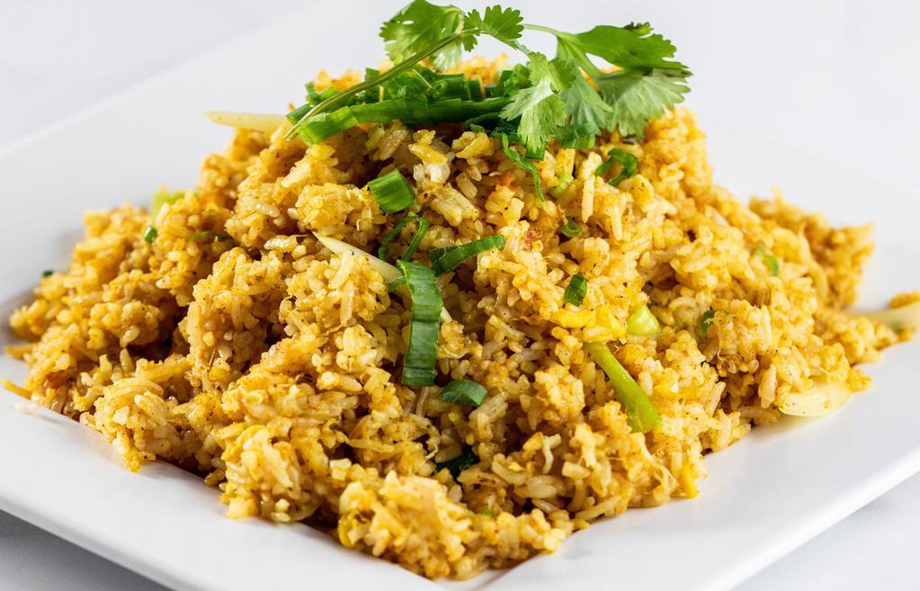 Curry Fried Rice · Fried rice stir fried with curry powder, choice of meat, egg, yellow onion, scallion and tomato.