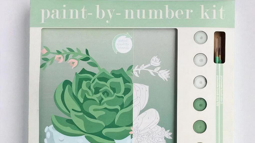 Blooming Succulent - Paint-By-Number Kit · This paint-by-number kit depicts a rich green succulent plant with pink flower blooms in a pale blue hobnail bowl. The pre-printed background features an art nouveau style fabric tablecloth.

Recommended for ages 13 and up.

Contents: (1) 8x10 artist-quality, un-mounted canvas with pre-printed background, (8) American-made, non-toxic, acrylic paints, (2) Princeton brush paintbrushes, instructions
