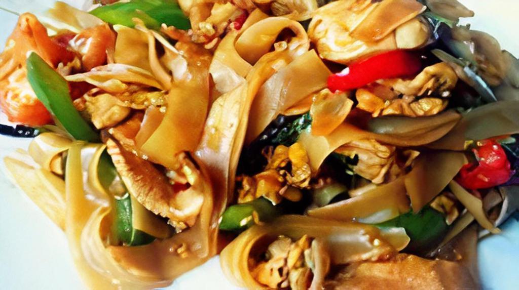Drunken Noodles · Stir fried wide rice noodles with zucchini, mushroom, bell pepper, green beans, basil cooked with red curry
