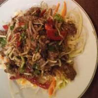 Yum Nuar · Exquisite grilled Angus sirloin steak mixed with a lime juice dressing, bell peppers, onions...