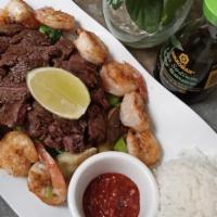 Steak And Shrimp · Grilled New York steak, with 5 sauté shrimp with garlic, onion, tomato, and mushrooms