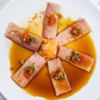Yellowtail Jalapeño · Hot & spicy. Sliced yellowtail with tomato and jalapeño in ponzu sauce and jalapeño oil.