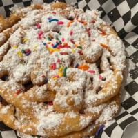 Classic Carnival Style Funnel Cake · Fresh golden funnel cake topped with powdered sugar.