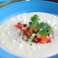 White Queso · Monterey Jack cheese melted with milk & peppers, served with homemade tortilla chips