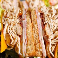 Classic Clubhouse · Ham, shredded grilled chicken breast, slices of bacon, a slice of cheddar cheese and Montere...