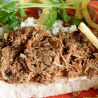Mexican Carnitas Torta · Marinated, pulled smoked pork. Served open faced with shredded lettuce, tomato, onions, cila...