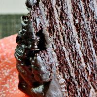 Chocolate Addiction Cake · Triple layered, double fudge rich chocolate cake. Served warm and dusted with powdered sugar.