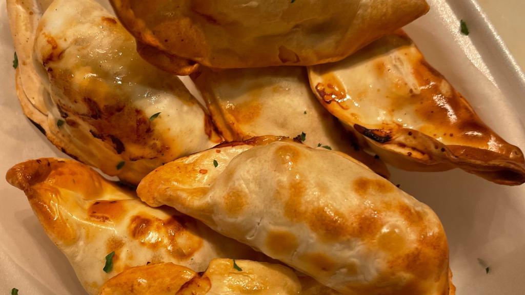 Gyoza (7 Pieces) · a Japanese dish consisting of wonton wrappers stuffed with pork and cabbage.
