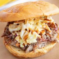 Notorious P.I.G · Slab's original BBQ classic. Pulled pork topped with mustard coleslaw and backyard red. Add ...