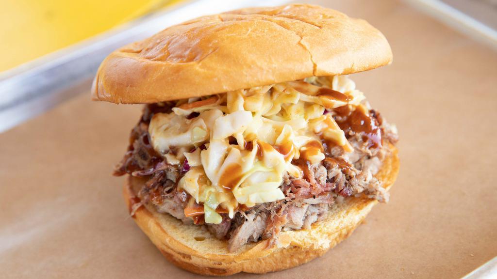 Notorious P.I.G · Slab's original BBQ classic. Pulled pork topped with mustard coleslaw and backyard red. Add jalapeños and gold rush sauce on request.