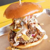 The Donk · One pound sandwich stacked with every slab smoked meat available & topped with pickles, onio...