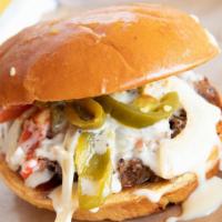 El Jefe · Black angus brisket topped with grilled onions, peppers, jalapenos, queso & BBQ sauce, toppe...