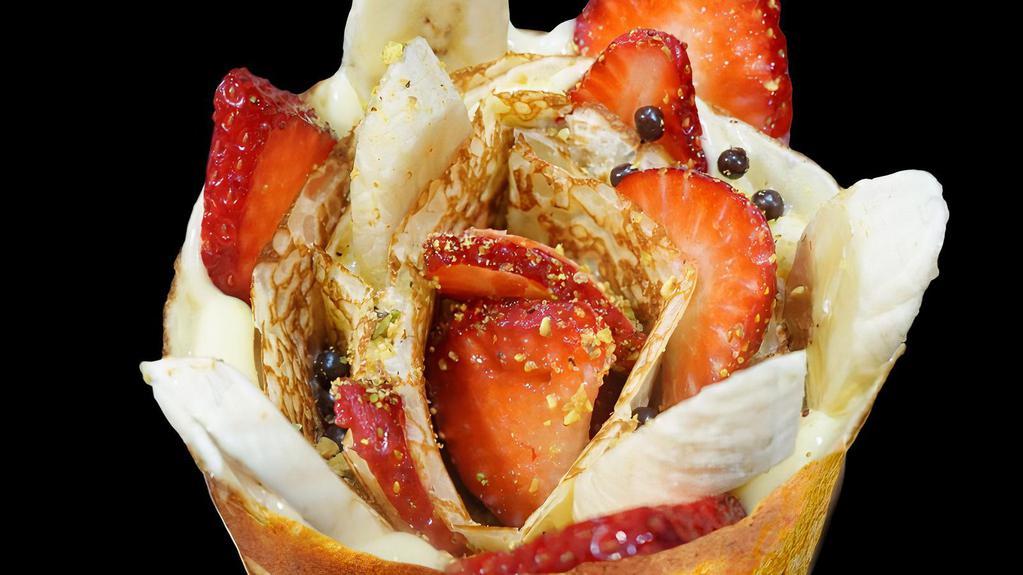 Strawberry Banana · Sliced strawberries, sliced bananas, custard cream whipped yogurt, chocolate pearls. Crushed pistachio.
