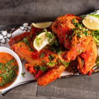 Tandoori Chicken · Spring chicken marinated overnight in a prized marinade, then broiled on charcoal.