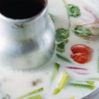 (S) Tom Kha · Coconut milk soup with lemon grass, galangal, fresh mushroom, scallion, tomato and lime juice.