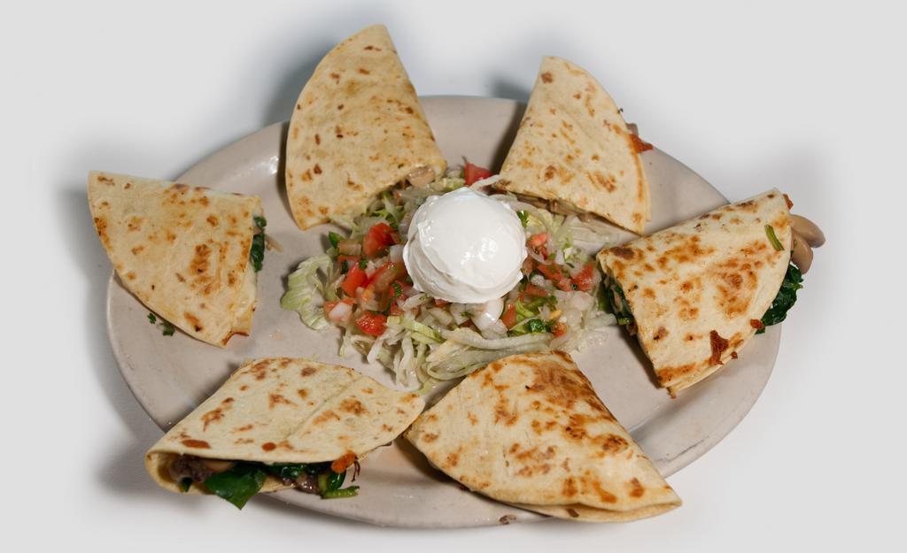 Quesadillas Mexicanas · Three flour quesadillas filled with scrambled eggs, white cheese and your choice of Mexican chorizo or bacon. Served with refried beans.