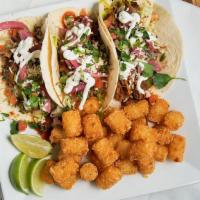 Tacos · 3 tacos topped with taco sauce, pickled red onions, lettuce, pico de gallo, crema, and garni...