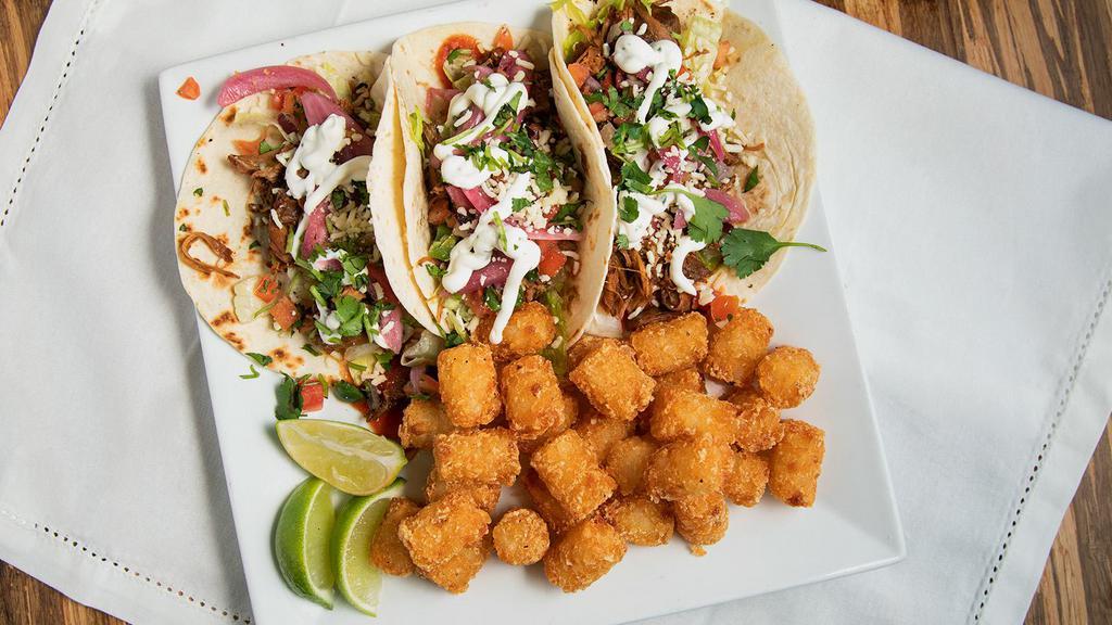 Tacos · 3 tacos topped with taco sauce, pickled red onions, lettuce, pico de gallo, crema, and garnished with cilantro. Served on corn tortillas. No mix and match, please.
