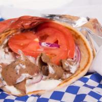 Gyro · Warm pita wrapped around choice of meat: Beef/Lamb/Chicken/Veggie with tomatoes and red onio...