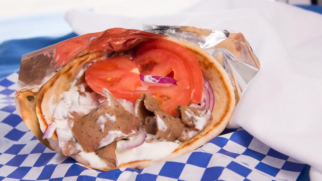 Gyro · Warm pita wrapped around choice of meat: Beef/Lamb/Chicken/Veggie with tomatoes and red onions topped off with tzatziki sauce.