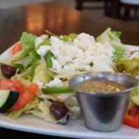 Greek Salad · Iceberg and romaine lettuce, tomatoes, cucumbers, onions, green peppers, olives, pepperoncin...
