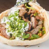 Gyros Pita · Combination of beef and lamb cooked on a rotisseire, rolled in Greek pita with lettuce, toma...